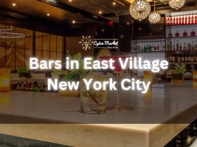 Bars in East Village New York City - a bar with nice lights and good ambience, 2 glass of cocktails, and candlelights on the table