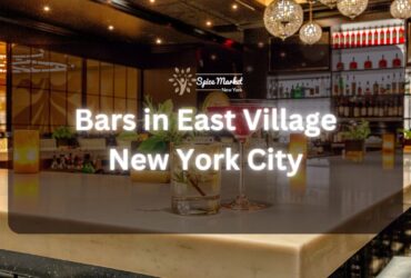 Bars in East Village New York City - a bar with nice lights and good ambience, 2 glass of cocktails, and candlelights on the table