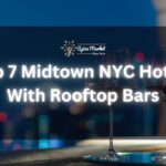 Top 7 Midtown NYC Hotels With Rooftop Bars - a rooftop bar with a table and 2 glasses of wine and a beautiful city lights view