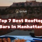 Top 7 Best Rooftop Bars In Manhattan NYC - food and cocktails on a table with a nice view from a rooftop bar