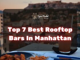 Top 7 Best Rooftop Bars In Manhattan NYC - food and cocktails on a table with a nice view from a rooftop bar
