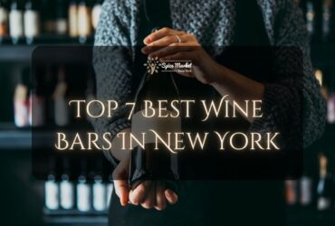 Top 7 Best Wine Bars In New York - a bartender holding a nice bottle of wine in a bar