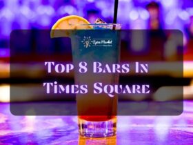 Top 8 Bars In Times Square NYC - a nice glass of cocktail with ice and lemon on top placed on a table inside a bar