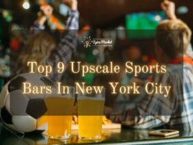 Top 9 Upscale Sports Bars In New York City - a soccer ball and two glasses of beer on a table and two people drinking while enjoying watch sports on TV inside a sports bar